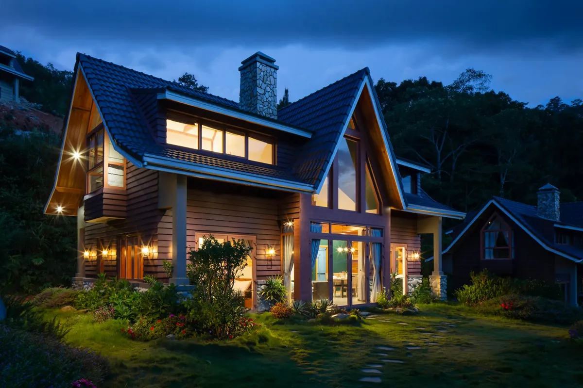 A modern Orleans home at blue hour with warm-lit windows