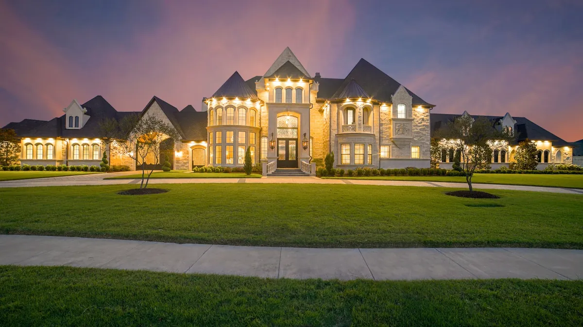 A grand Rockland estate lit at dusk