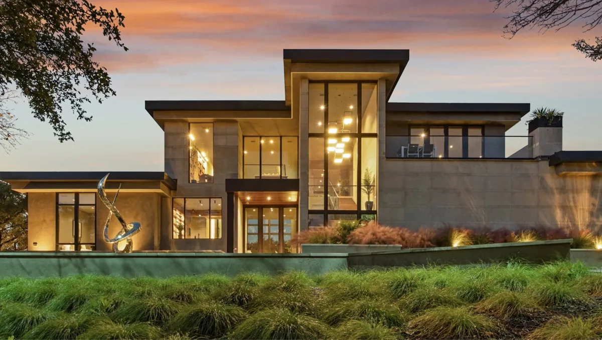 A warm-lit modern Cumberland home at dusk